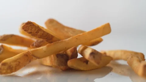 French fries falling on white surface. Slow Motion. Stock Footage 89811771