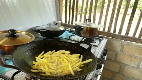 French Fries Frying in Rustic Kitchen Stock Footage 325834427