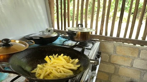 French Fries Frying in Rustic Kitchen Stock Footage 325834529