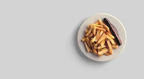 French fries in a plate on a grey background. close-up view. Stock Photos