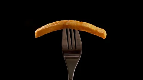 French fry on a fork rotate - camera zoom in 動画素材 107697206