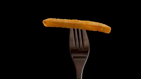 French fry on a fork rotate, gets a stripe of ketchup - camera zoom in Stock Footage 107697281
