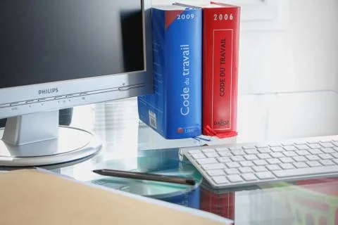 French labor code book pictured with computer in studio 스톡 사진