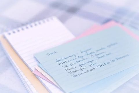 French; Learning New Language Writing Greetings on the Notebook Stock Photos