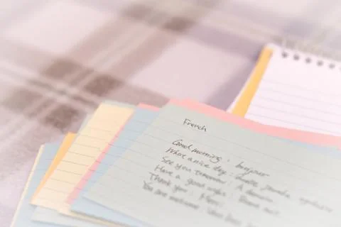 French; Learning New Language Writing Greetings on the Notebook Stock Photos