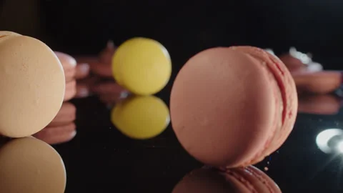 French macarons on a black, reflective background. Stock Footage 149127018