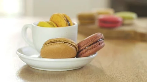 French macarons in white cup and on wooden tray. Stock Footage 51313083