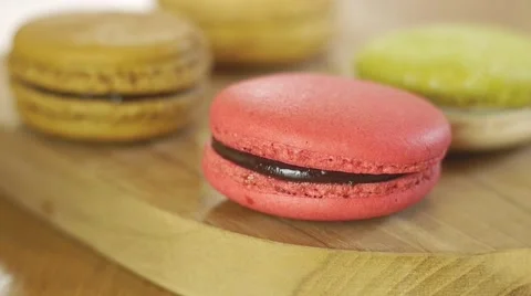 French macarons in white cup and on wooden tray. Stock Footage 51313100