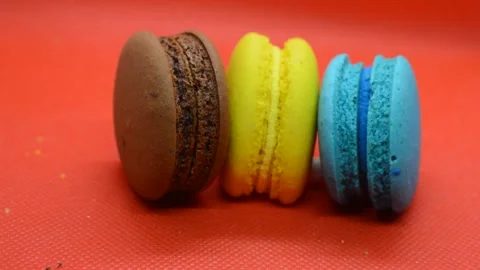 French macaroons on a red background. Stock Footage 145159044