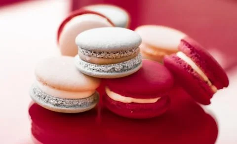 French macaroons on wine red background, parisian chic cafe dessert, sweet fo Stockfoto's