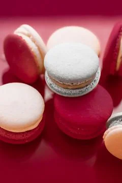 French macaroons on wine red background, parisian chic cafe dessert, sweet fo Stock Photos