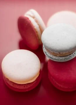 French macaroons on wine red background, parisian chic cafe dessert, sweet fo Stock Photos
