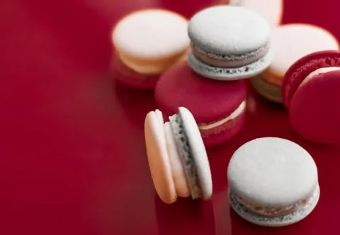 French macaroons on wine red background, parisian chic cafe dessert, sweet fo 스톡 사진