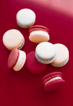 French macaroons on wine red background, parisian chic cafe dessert, sweet fo Stockfoto's