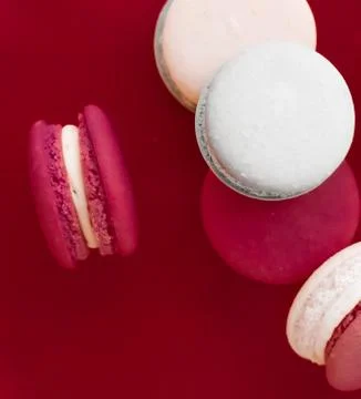 French macaroons on wine red background, parisian chic cafe dessert, sweet fo Stockfoto's