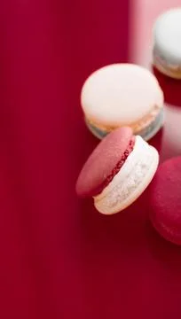 French macaroons on wine red background, parisian chic cafe dessert, sweet fo 스톡 사진