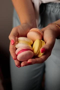 French macaroons in woman's hands Stock Photos