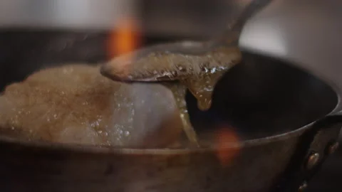 French Man prepares a dish in a pan with butter, cooking a fish, french cook Stock Footage 172073277