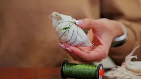 French Manicure Hands Wrap Easter Egg With Flowers and Gauze for Natural Dyeing Stock Footage 344008046