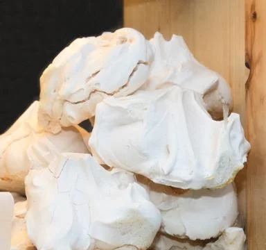 French meringue vanilla cookies stack pile one over another for sale on baker Stock Photos