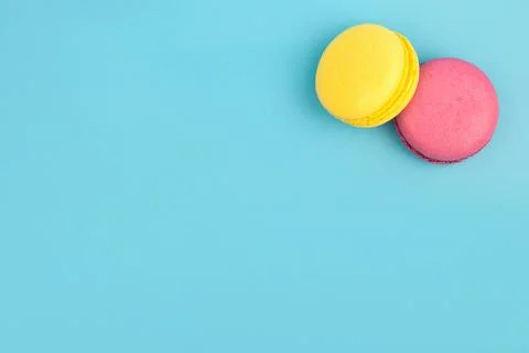 French multicolored macaroons on a blue background. Dessert. Stock Photos