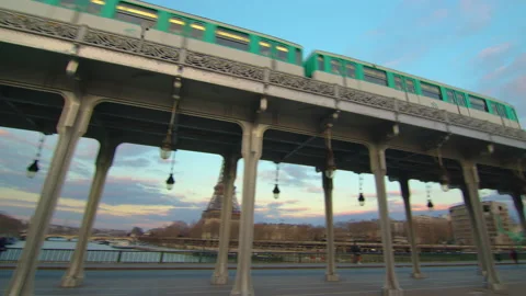 French old metro passes over the famous metal bridge in the center of Paris Stock Footage 235152777