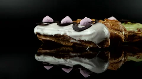 French pastry glazed Eclairs with cream and chocolate, loop Stock Footage 63853371