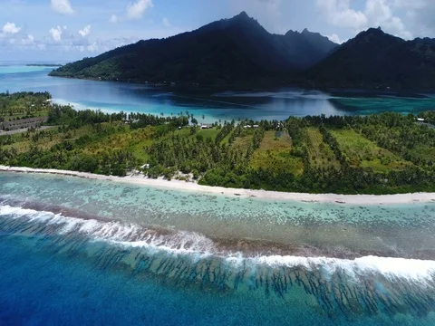 French Polynesia Tahiti aerial view of island Huahine and Motu coral reef lagoon Stock Footage