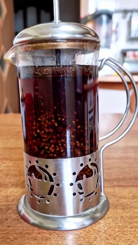 French Press Brewing Tea with Grains Floating Stock Footage 321964248