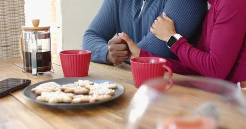 With French press coffee brewing, diverse couple at dining table interlocking Stock Footage 343837431