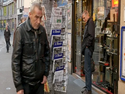 French press reporting about Bataclan Terrorist attack in Paris seniors buying Stock Footage 80624669