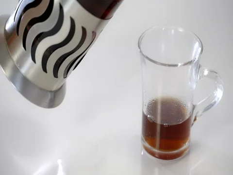 French Press with tea, tea is poured in a transparent Cup. On a white background Video stock 73803824