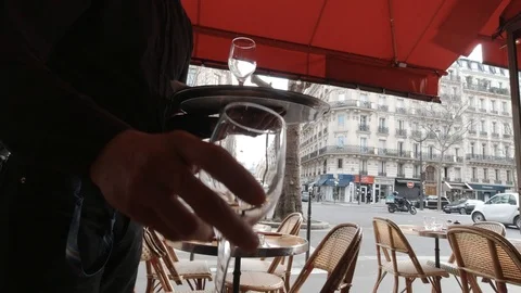 French Server handling two glasses of wine in Paris Cafe Stock Footage 126644482