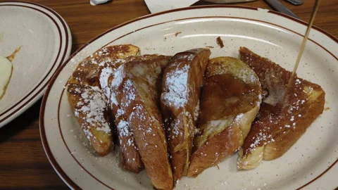 French toast with maple syrup on white plate ready for breakfast Video stock 157347237