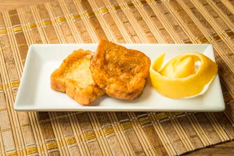 French toast in a rectangular dish on a bamboo mat Stock Photos