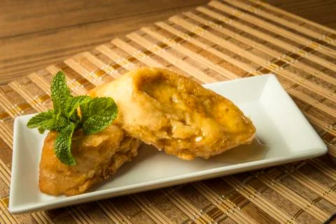 French toast in a rectangular dish on a bamboo mat Stock Photos