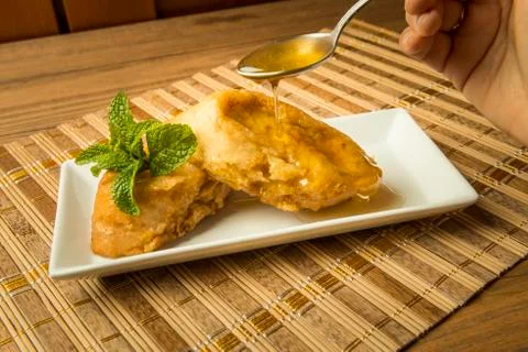 French toast in a rectangular dish on a bamboo mat Stock Photos