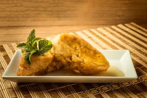 French toast in a rectangular dish on a bamboo mat Stock Photos