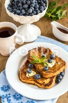 French toasts with fresh blueberries and maple syrup Stock Photos