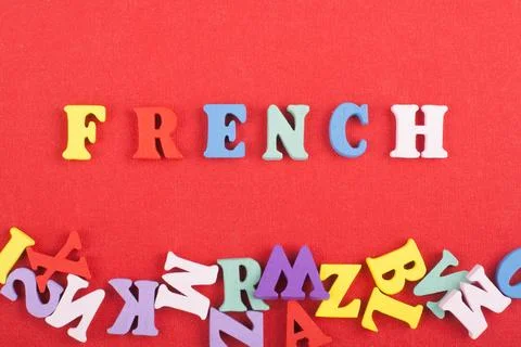 FRENCH word on red background composed from colorful abc alphabet block woo.. Stock Photos
