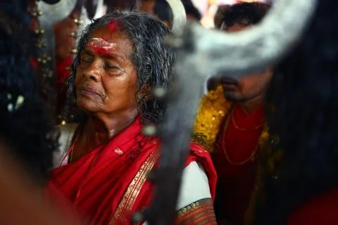 A frenzied mob of devotees led by oracles walk around the temple Stock Photos