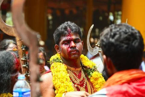A frenzied mob of devotees led by oracles walk around the temple Stock Photos