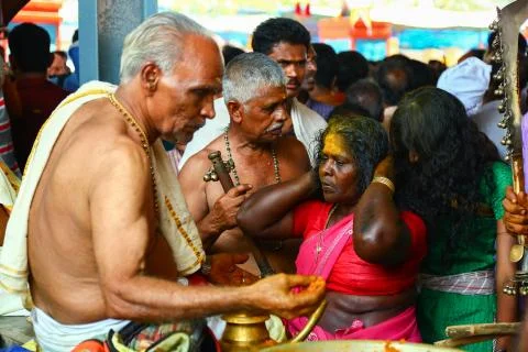 A frenzied mob of devotees led by oracles walk around the temple Stock Photos