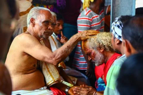 A frenzied mob of devotees led by oracles walk around the temple Stock Photos