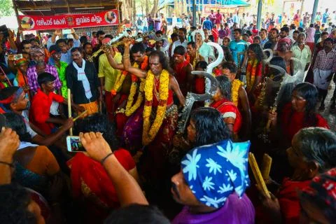 A frenzied mob of devotees led by oracles walk around the temple Stock Photos