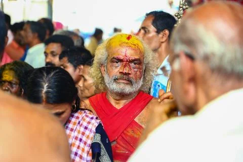 A frenzied mob of devotees led by oracles walk around the temple Stock Photos