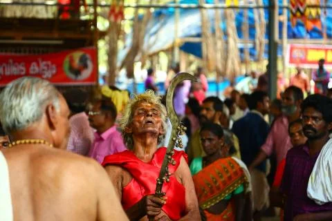 A frenzied mob of devotees led by oracles walk around the temple Stock Photos