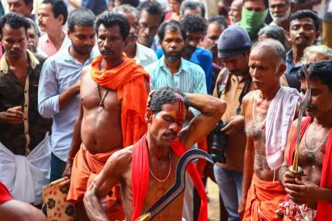 A frenzied mob of devotees led by oracles walk around the temple Stock Photos