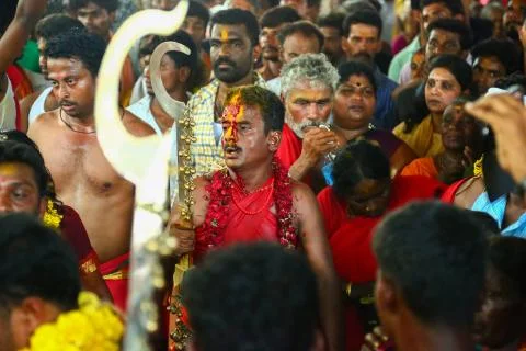 A frenzied mob of devotees led by oracles walk around the temple Foto stock