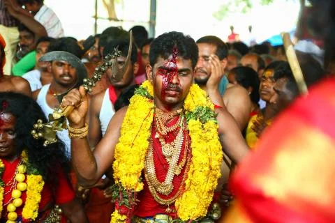 A frenzied mob of devotees led by oracles walk around the temple Stock Photos